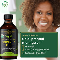 Smiling woman beside a 4 fl oz bottle of cold-pressed moringa oil
